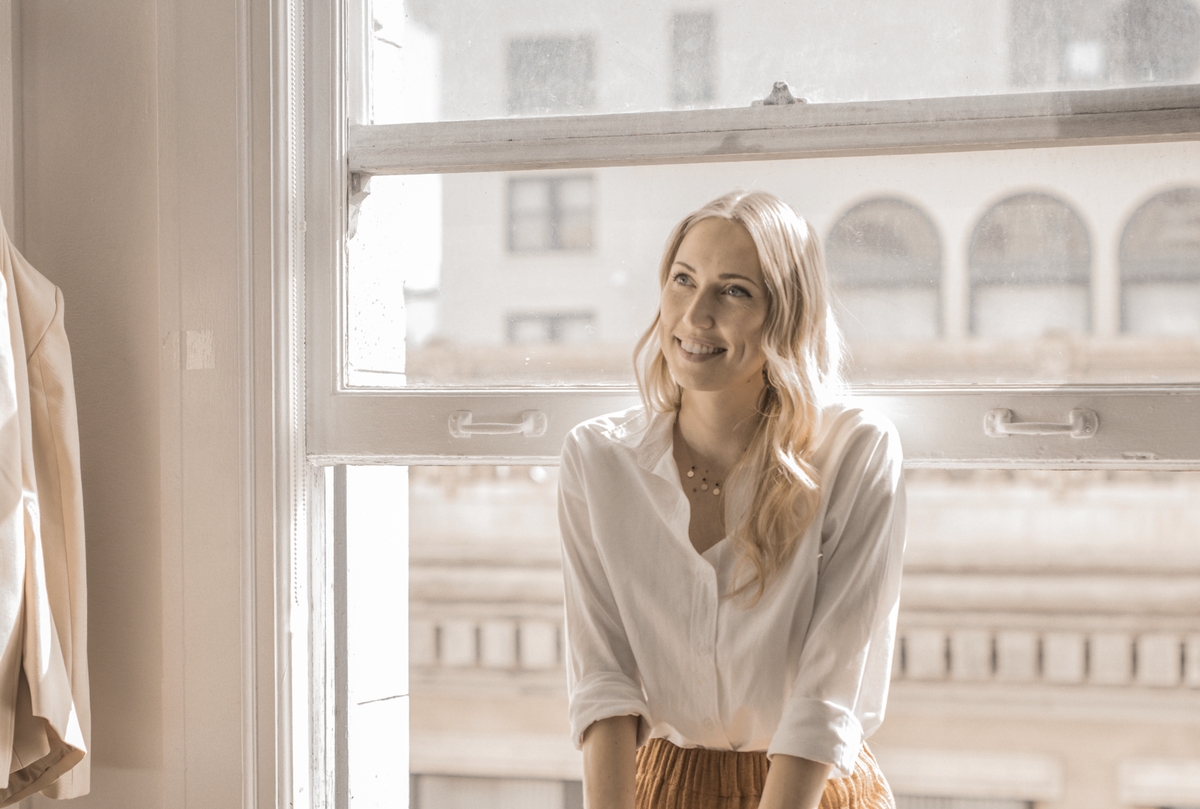 Smiling blonde businesswoman sitting on the balcony portrait